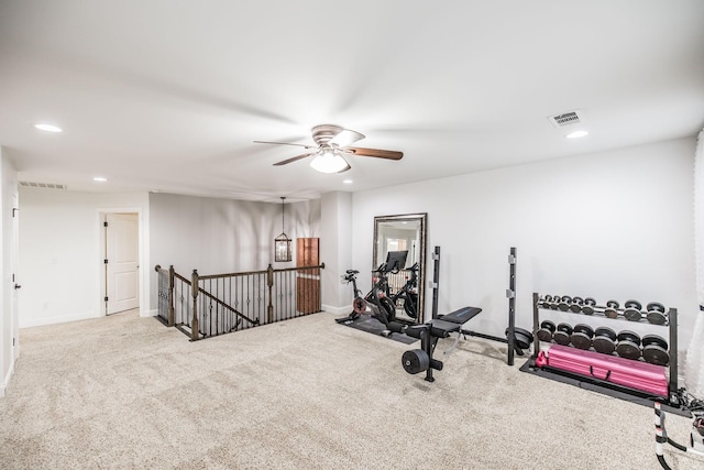 exercise room featuring ceiling fan and carpet flooring