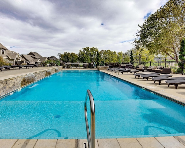 view of pool featuring pool water feature and a patio area