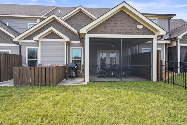 back of house with french doors, a patio area, a lawn, ceiling fan, and a sunroom