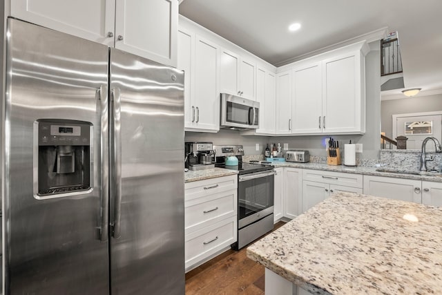 kitchen with white cabinetry, stainless steel appliances, dark wood-type flooring, and sink