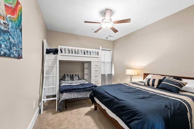 bedroom featuring light colored carpet and ceiling fan