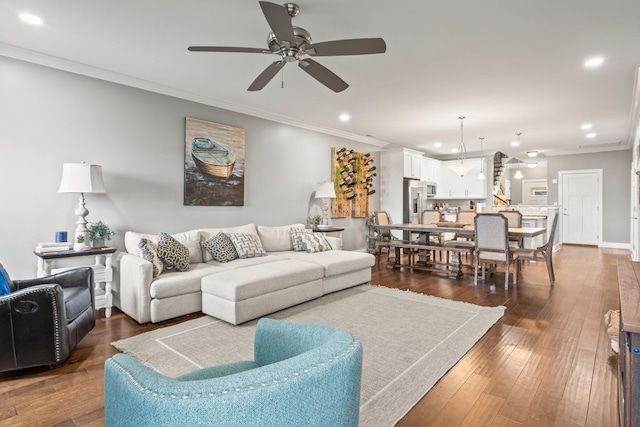 living room with ceiling fan, ornamental molding, and dark hardwood / wood-style floors