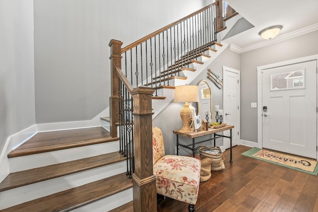 foyer entrance featuring crown molding and dark hardwood / wood-style floors