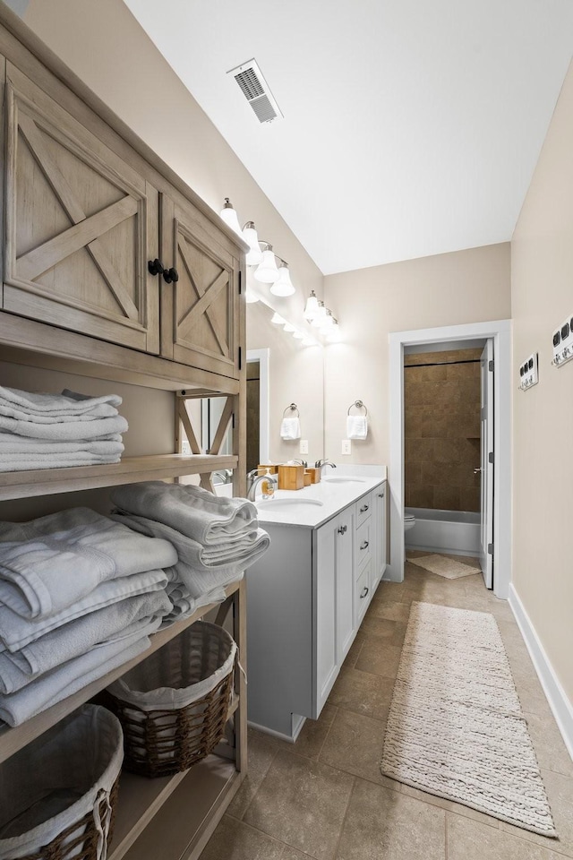 bathroom with vanity and a tub