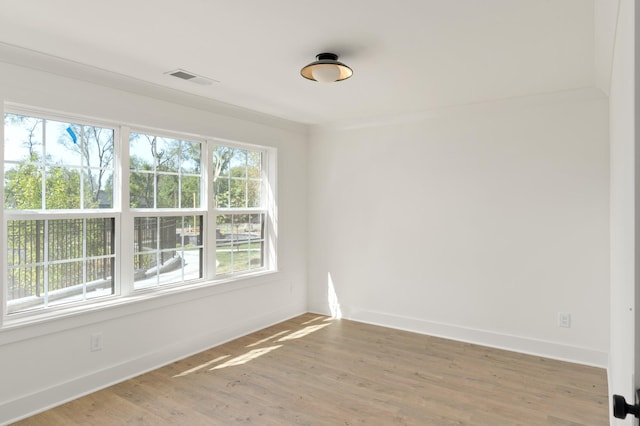 unfurnished room with hardwood / wood-style flooring