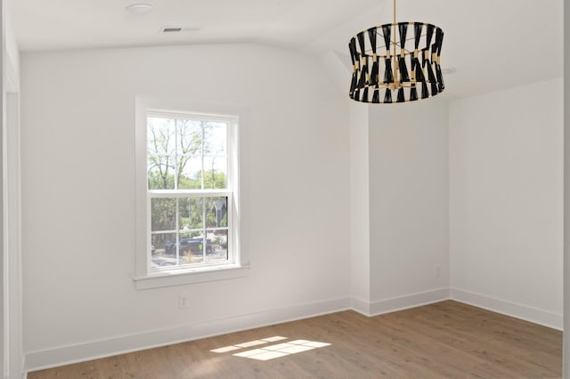 unfurnished room with wood-type flooring and lofted ceiling