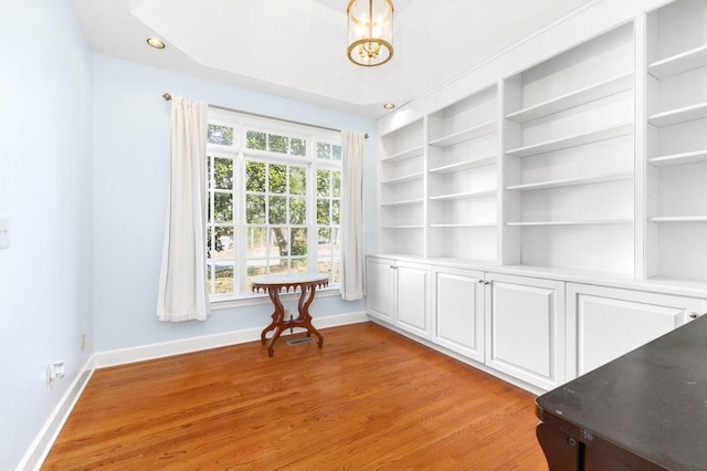 interior space with built in features and light hardwood / wood-style floors