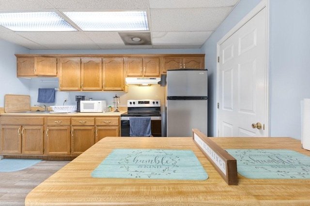 kitchen with a drop ceiling and appliances with stainless steel finishes