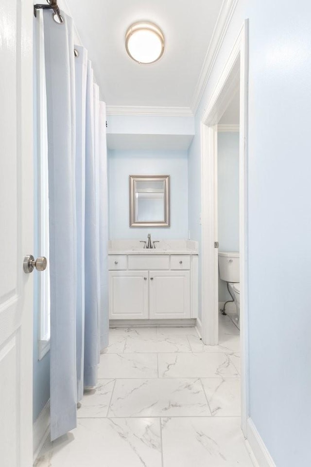 bathroom featuring ornamental molding, toilet, and vanity