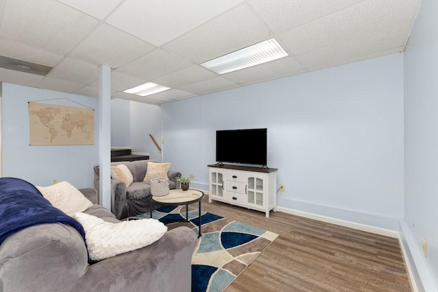 living room with a drop ceiling and hardwood / wood-style flooring