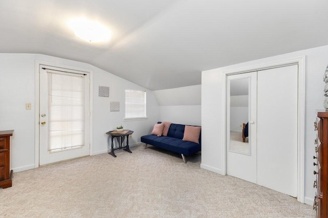 sitting room featuring vaulted ceiling and light carpet