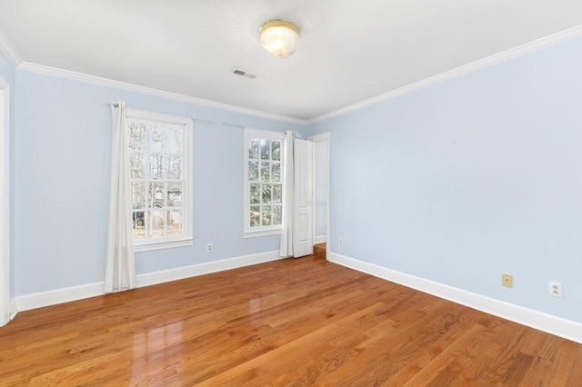 unfurnished room with crown molding and light hardwood / wood-style floors