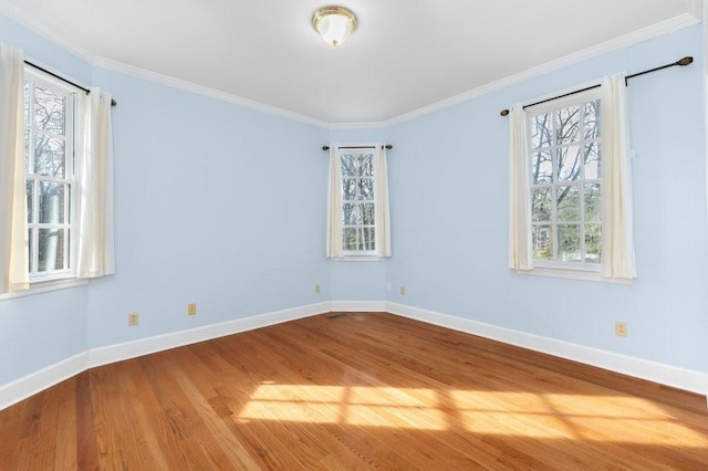 unfurnished room featuring hardwood / wood-style floors, plenty of natural light, and ornamental molding