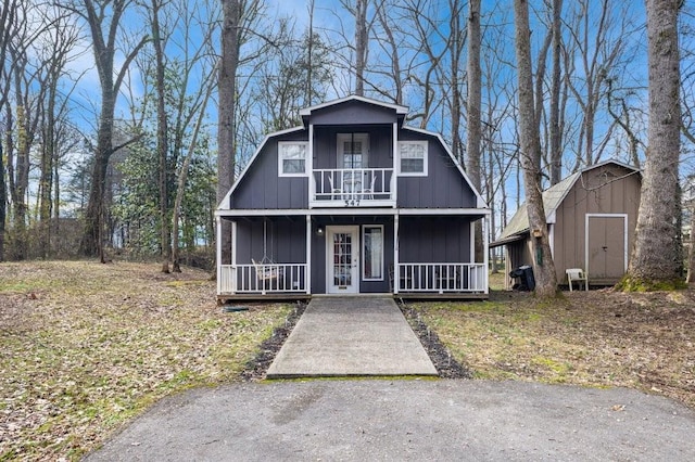 view of front of home featuring a storage unit and covered porch