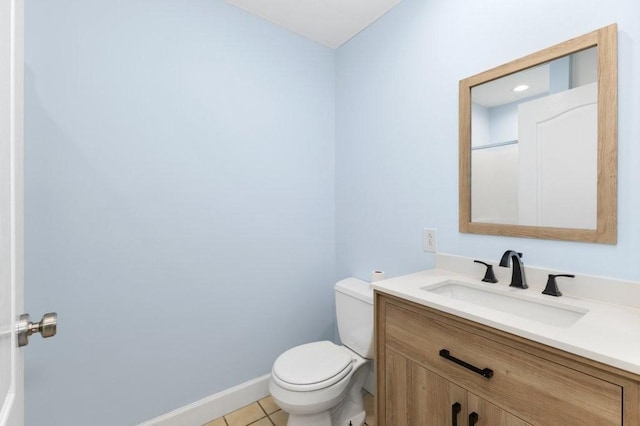 bathroom with vanity, toilet, and tile patterned flooring