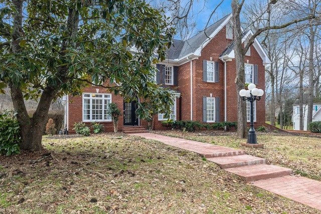 view of property featuring a front lawn