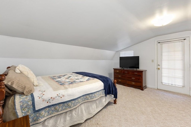 bedroom with lofted ceiling and light colored carpet