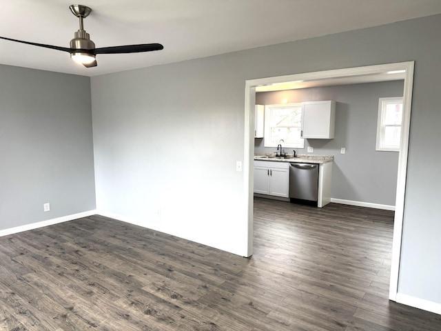 spare room featuring ceiling fan, dark hardwood / wood-style flooring, and sink