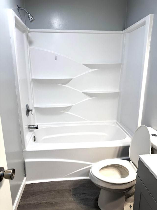 full bathroom with hardwood / wood-style flooring, vanity, toilet, and shower / bathing tub combination