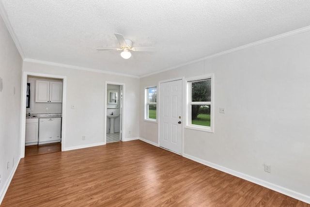 unfurnished room with hardwood / wood-style floors, a textured ceiling, ornamental molding, and ceiling fan