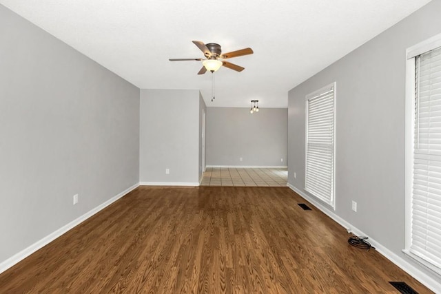 interior space with dark wood-type flooring and ceiling fan