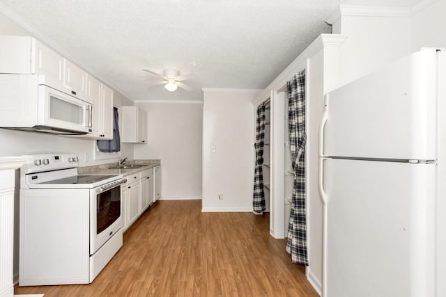 kitchen featuring white appliances, ceiling fan, ornamental molding, light hardwood / wood-style floors, and white cabinets