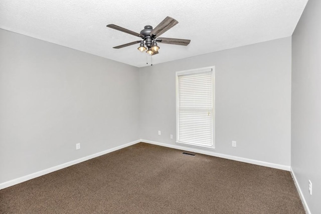 carpeted spare room with ceiling fan and a textured ceiling