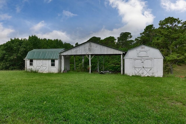 view of outdoor structure featuring a lawn