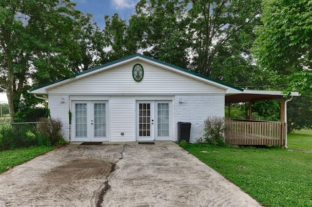 rear view of property with a yard and french doors