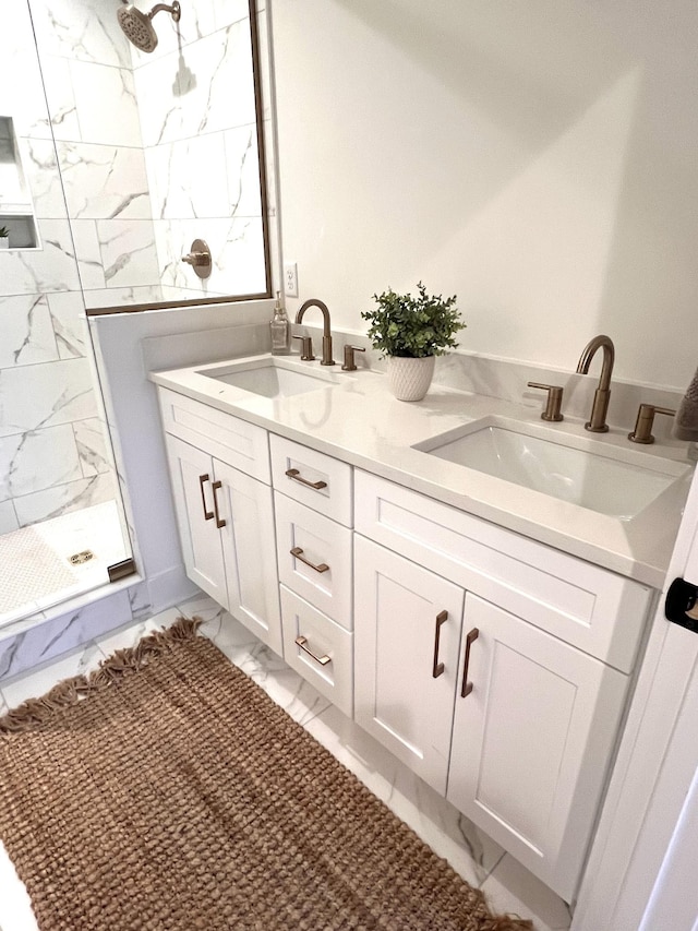 bathroom with vanity and a tile shower