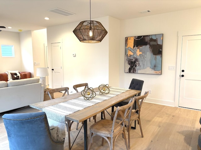 dining space with light hardwood / wood-style flooring