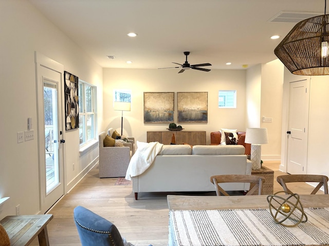 living room featuring ceiling fan and light wood-type flooring