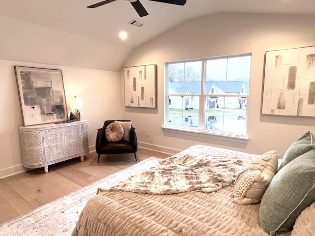 bedroom featuring wood-type flooring, vaulted ceiling, and ceiling fan