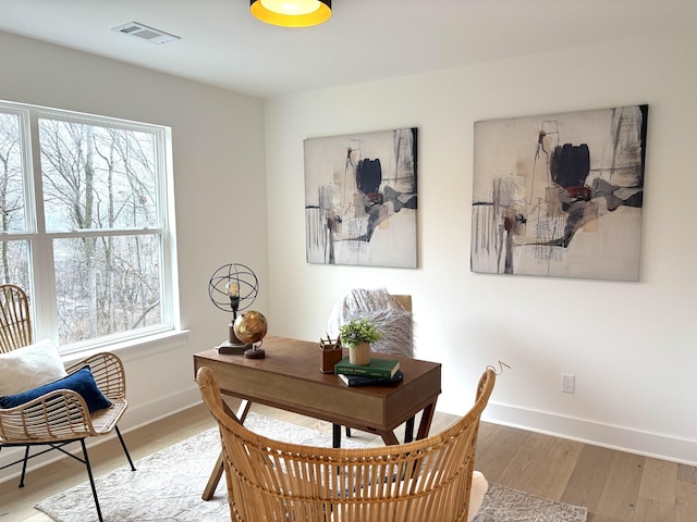 dining space with hardwood / wood-style floors