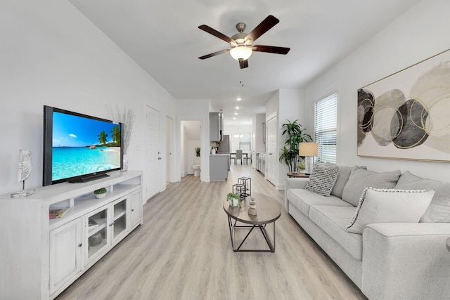 living room featuring ceiling fan and light wood finished floors