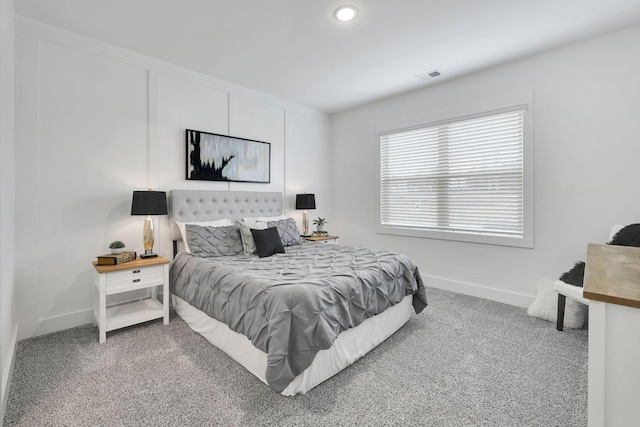 bedroom with visible vents, baseboards, and carpet