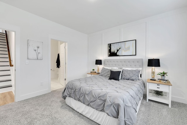 carpeted bedroom featuring ensuite bath