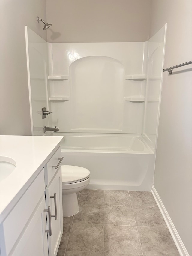 full bath with vanity, baseboards, bathtub / shower combination, tile patterned floors, and toilet