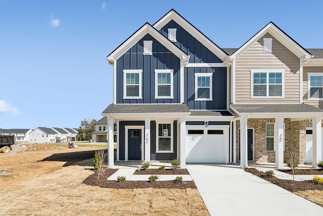 view of front of house featuring board and batten siding, a garage, covered porch, and driveway