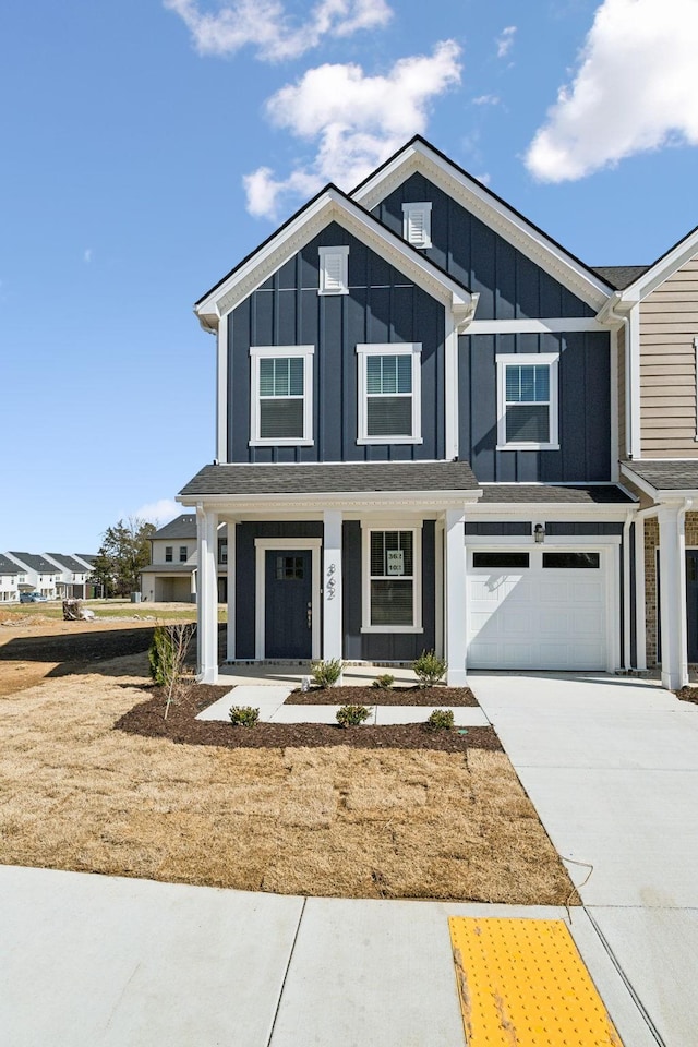 view of front of house with board and batten siding, concrete driveway, and an attached garage