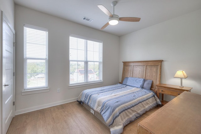 bedroom with light hardwood / wood-style floors and ceiling fan