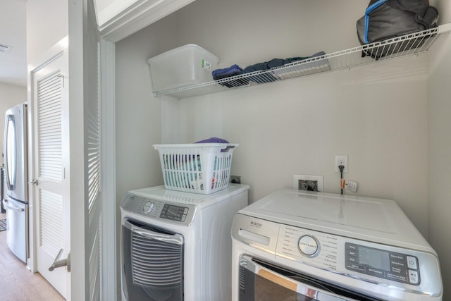 clothes washing area featuring washing machine and clothes dryer