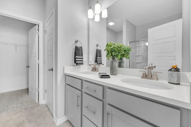 bathroom featuring vanity, a shower with shower door, and tile patterned flooring