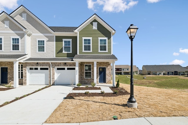 multi unit property featuring driveway, roof with shingles, covered porch, a front lawn, and a garage