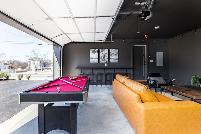 rec room with billiards, concrete flooring, and electric panel