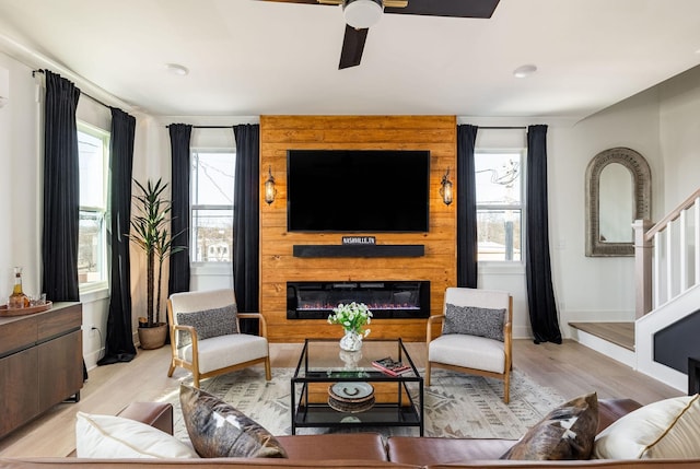 living room featuring ceiling fan and light wood-type flooring