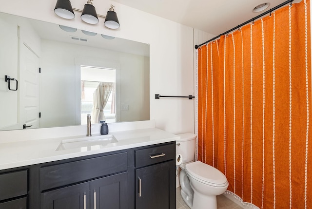 bathroom featuring vanity and toilet