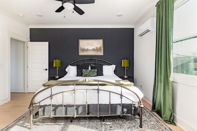 bedroom featuring crown molding, a wall unit AC, and light wood-type flooring