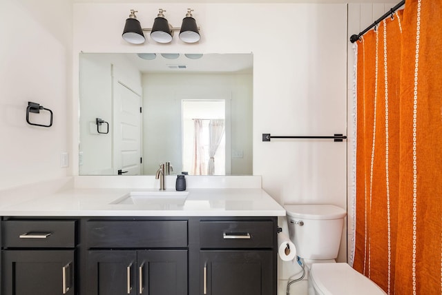 bathroom with vanity and toilet