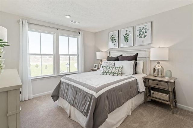 carpeted bedroom with a textured ceiling